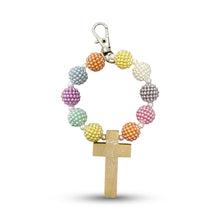 Load image into Gallery viewer, Denario con borlas en tonos pastel y cruz de madera, de Llena de Gracia
