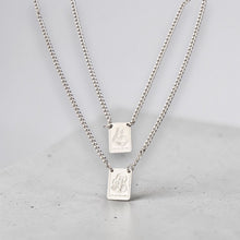 Load image into Gallery viewer, Collar Llena de Gracia con dos mini escapularios de acero quirúrgico bañado en rodio, Jesús y Virgen del Carmen.
